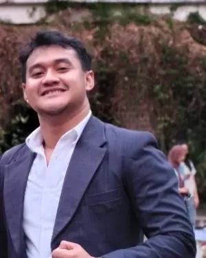 Eduardus Alvito Kristiadi, founder of DM Techworks, smiling in a navy blazer and white shirt